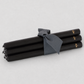 Three oversized 22-inch black taper candles tied with a grey ribbon, featuring a hand-embossed gold HG logo.