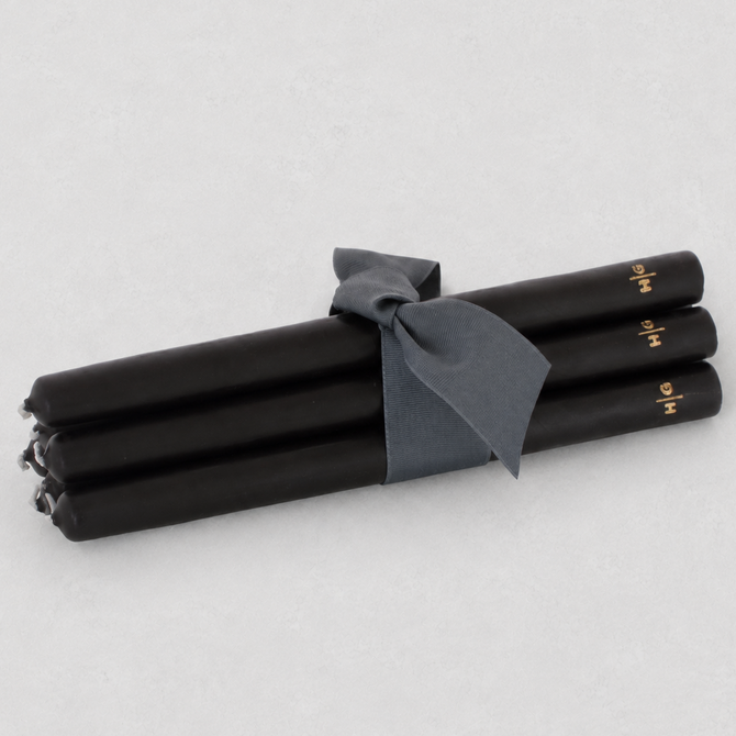Three oversized 22-inch black taper candles tied with a grey ribbon, featuring a hand-embossed gold HG logo.