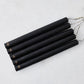 Set of five 10-inch black unscented taper candles with hand-embossed gold Hudson Grace logos on a white background.