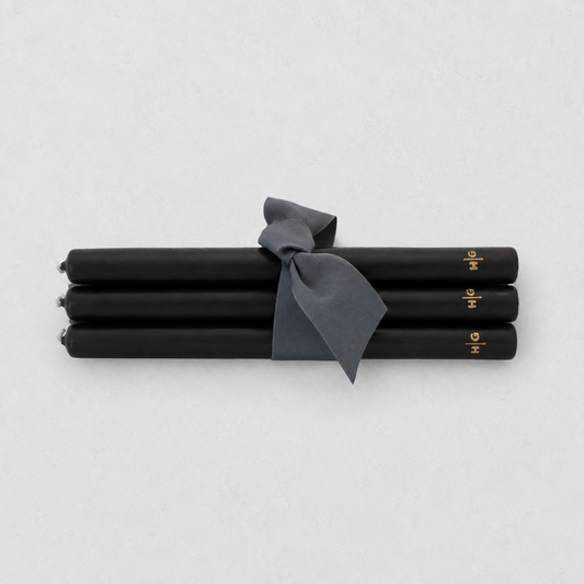 Set of five 10-inch black unscented taper candles tied with a grey ribbon, featuring a gold embossed Hudson Grace logo.