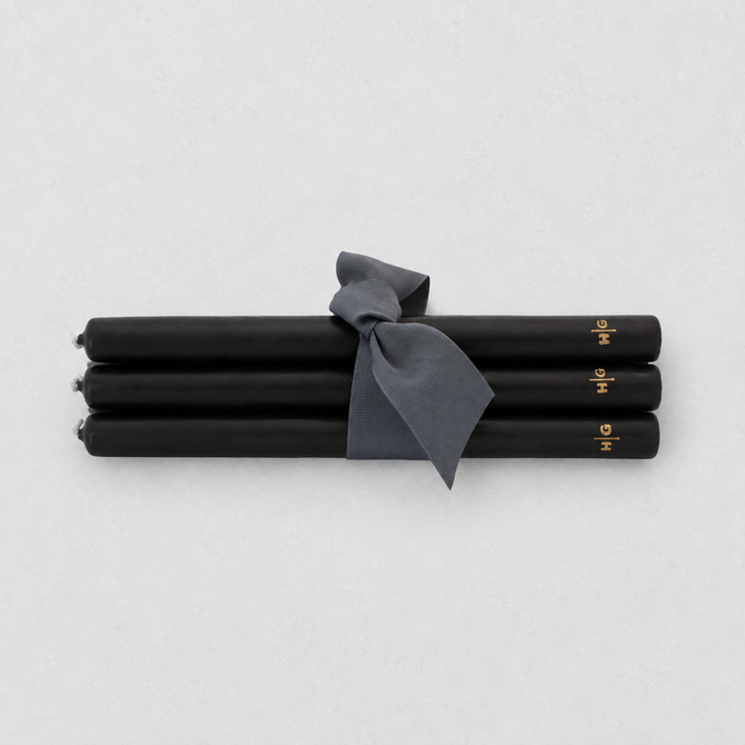 Set of five 10-inch black unscented taper candles tied with a grey ribbon, featuring a gold embossed Hudson Grace logo.