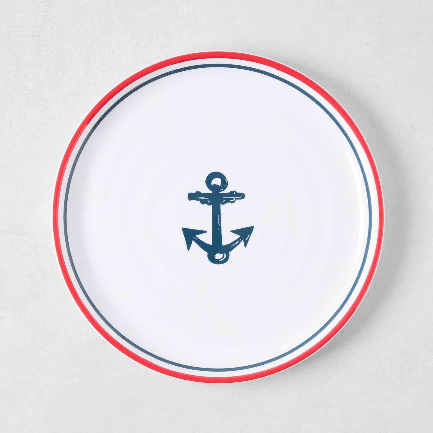 White melamine 8" salad plate with a navy blue anchor and red border.