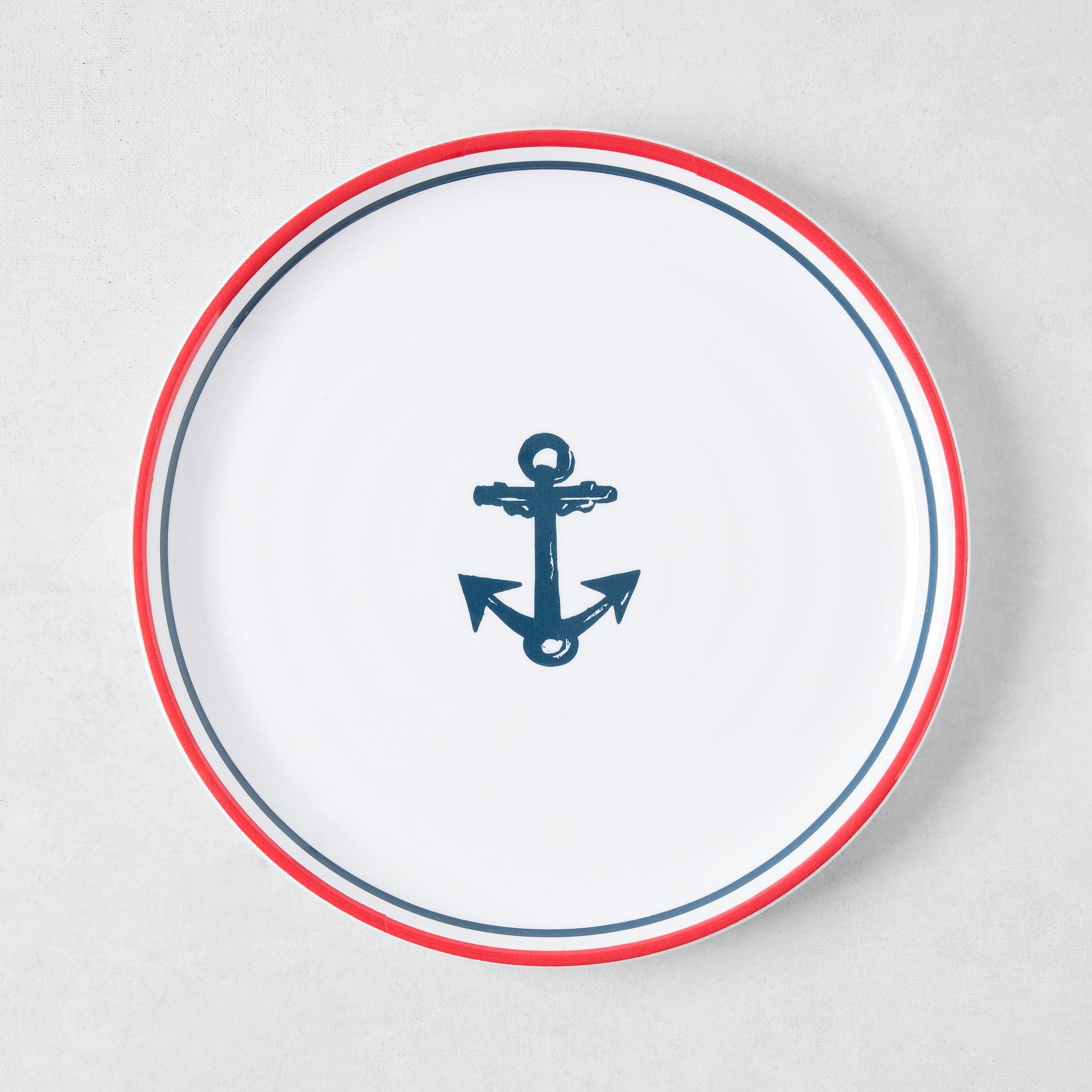 White melamine 8" salad plate with a navy blue anchor and red border.
