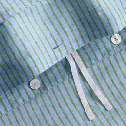 Blue and green striped washed linen duvet cover with white button closures and fabric ties.