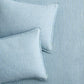 Two blue and green striped European washed linen euro shams on matching striped bedding.