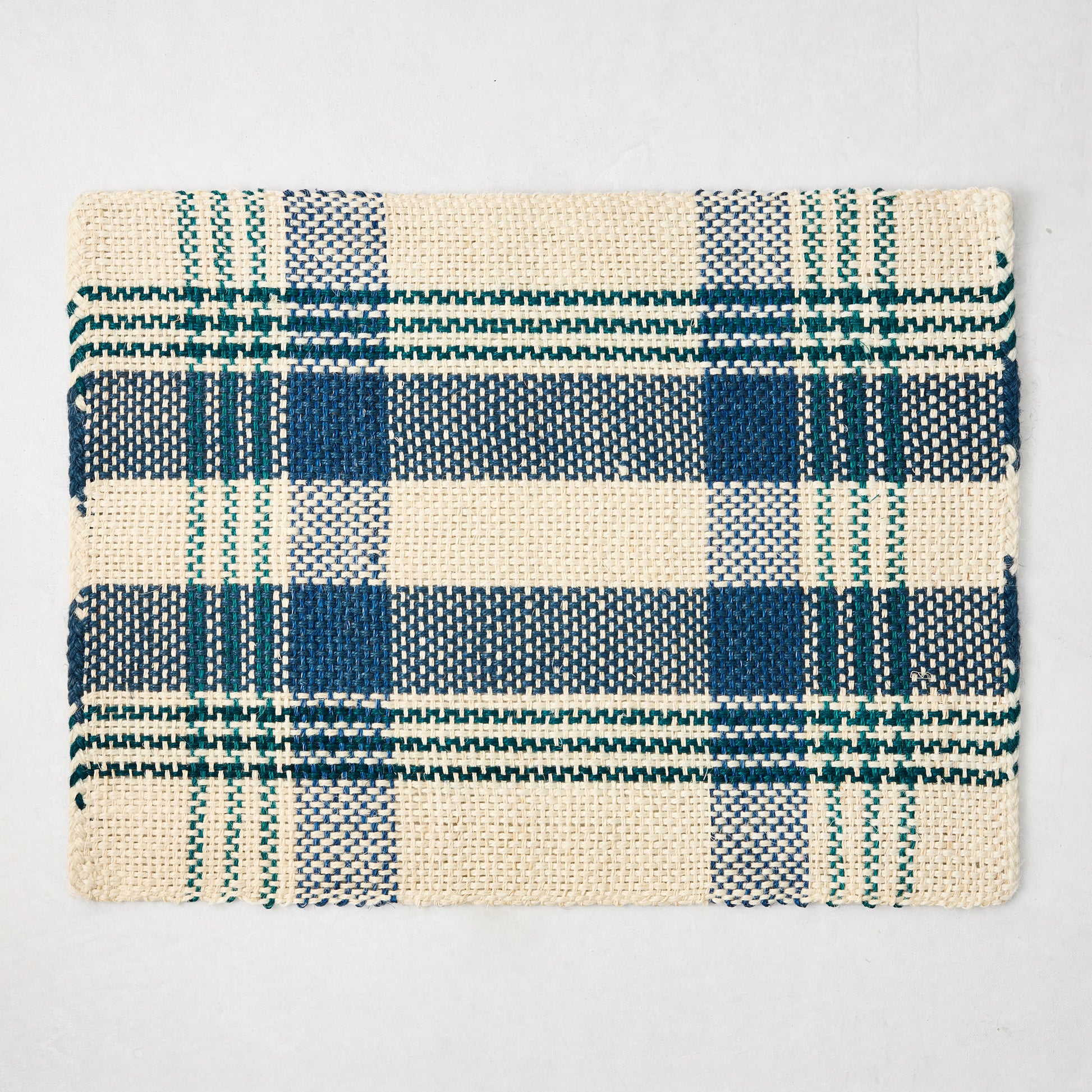 Blue and green woven plaid rectangular placemat made from abaca and jute, 19"W x 14"L.
