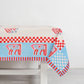 Blue and red horse block print cotton tablecloth with floral motifs and checkered trim.