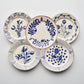 Set of 5 Blue Casa Nuno ceramic dinner plates with assorted hand-painted Talavera-style patterns.