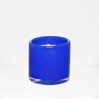 Blue votive glass candle holder, mouth-blown, hand-formed, 2.75"Dia x 2.75"H, with lit candle.