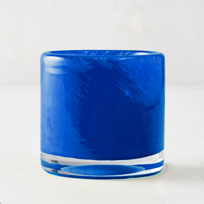 Blue votive glass candle holder, mouth-blown with unique swirls, clear base, 2.75"Dia x 2.75"H.