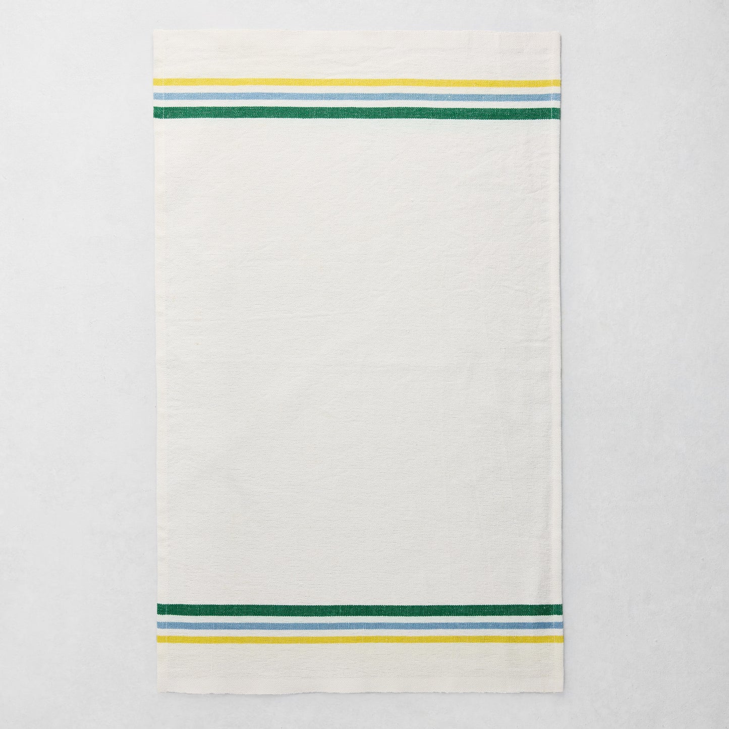 White cotton-linen hand towel with blue, green, and yellow triple stripes on top and bottom.