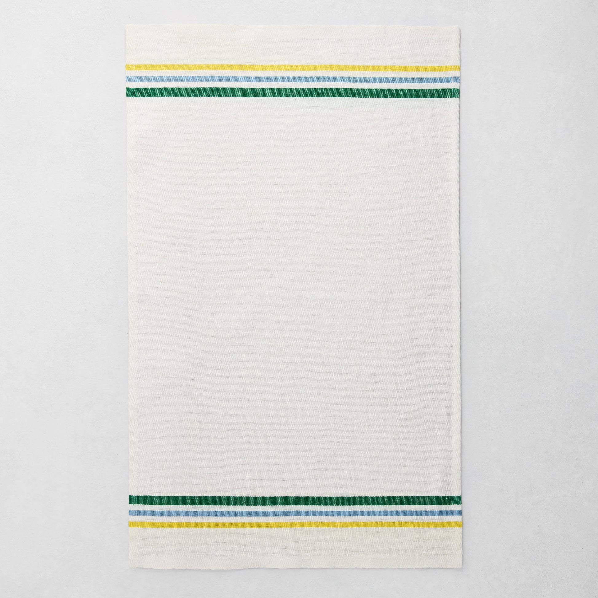 White cotton-linen hand towel with blue, green, and yellow triple stripes on top and bottom.