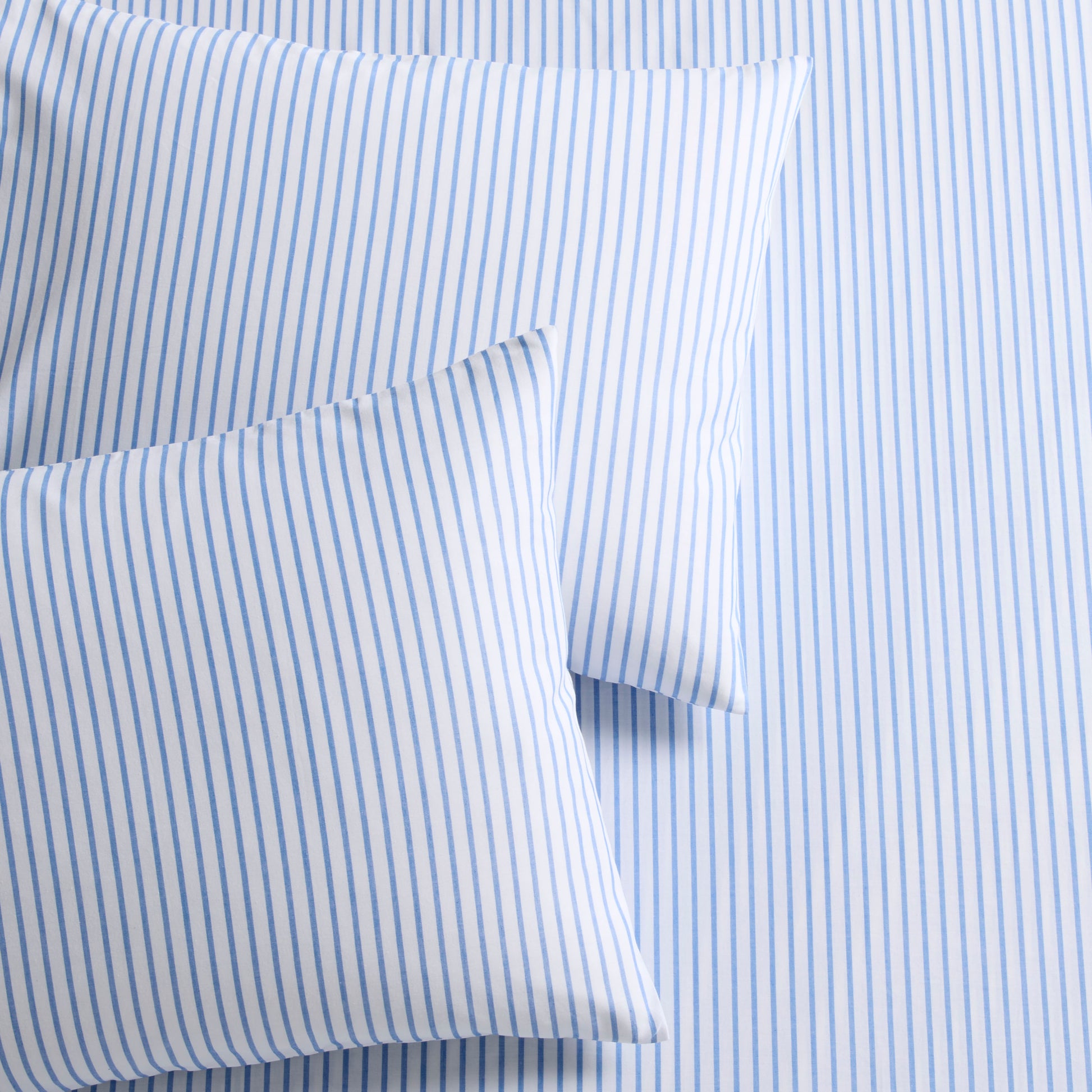 Blue Oxford thin stripe organic cotton duvet cover and two shams with tie closures.