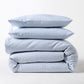 Stacked blue oxford thin stripe organic cotton duvet and shams set with tie closures.