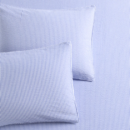 Blue seersucker stripe organic cotton duvet cover and two shams with button and envelope closures.