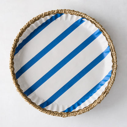 Round parchment liner with blue diagonal stripes in a woven straw basket.