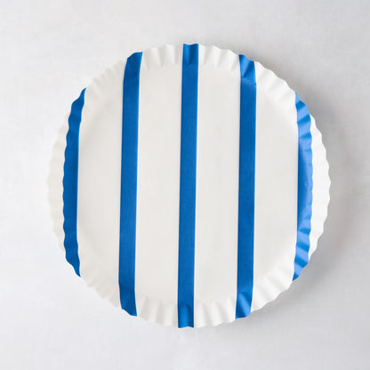 Round white parchment liner with vertical blue stripes and ruffled edges.