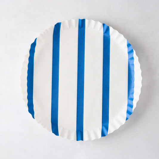 Round white parchment liner with vertical blue stripes and ruffled edges.