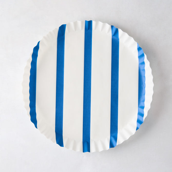 Round white parchment liner with vertical blue stripes and ruffled edges.