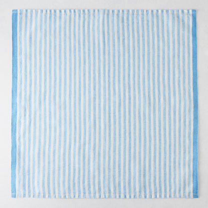 Blue Ticking Stripe Linen Napkin, 21" square, with thin light blue and white vertical stripes and a thicker blue border.