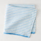 Folded blue and white ticking stripe linen napkin with a thicker blue border.