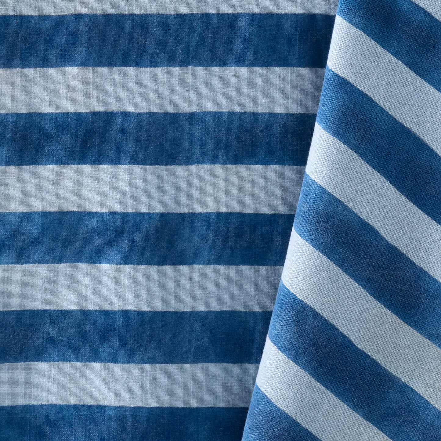 Blue Tonal Hampton Stripe Cotton Tablecloth with bold blue and light blue stripes.