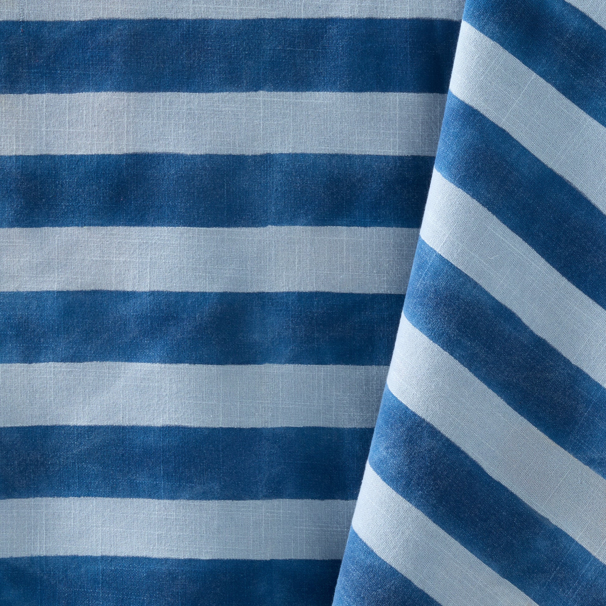 Blue Tonal Hampton Stripe Cotton Tablecloth with bold blue and light blue stripes.