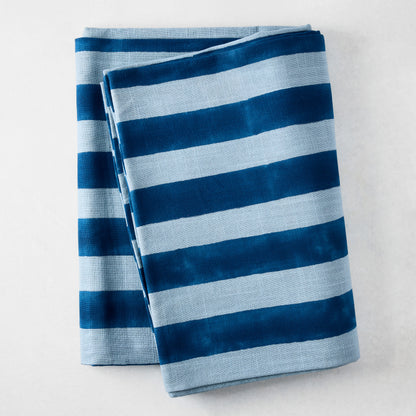 Blue Tonal Hampton Stripe Cotton Tablecloth, 70"W x 108"L, folded with bold and light blue stripes.