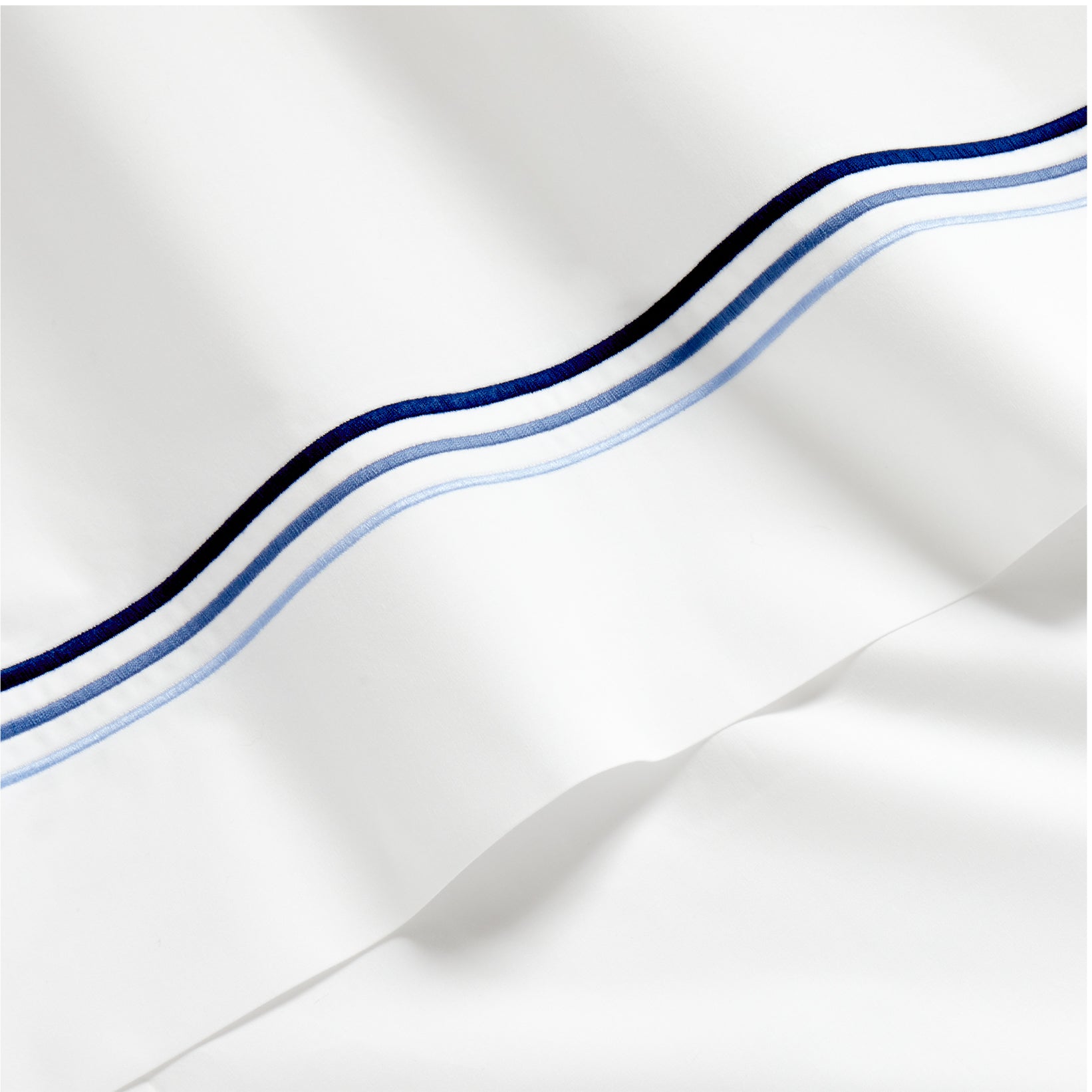 White percale sheet with blue triple-stitch detail.