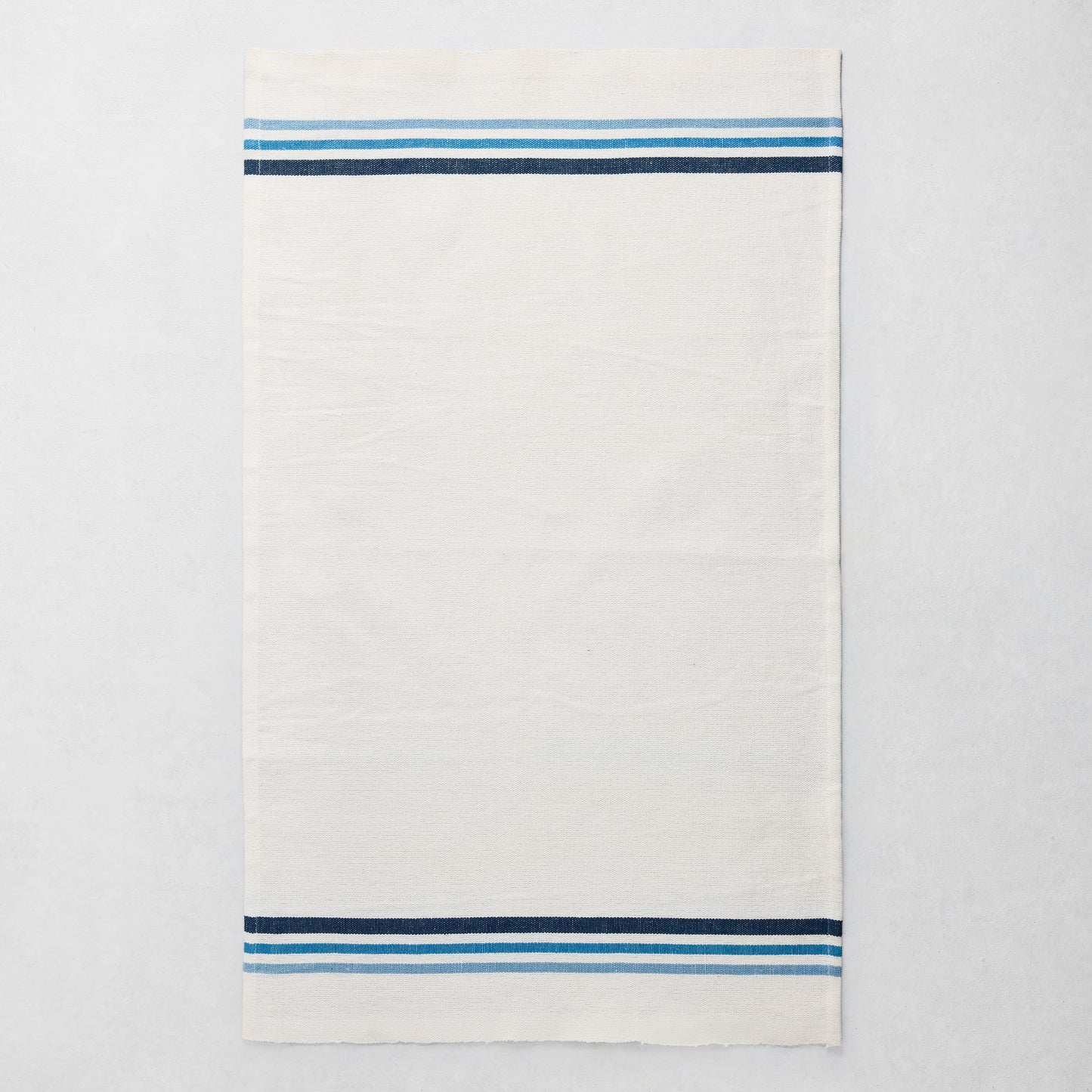 White cotton-linen hand towel with blue triple stripes at top and bottom, 28"L x 18"W.