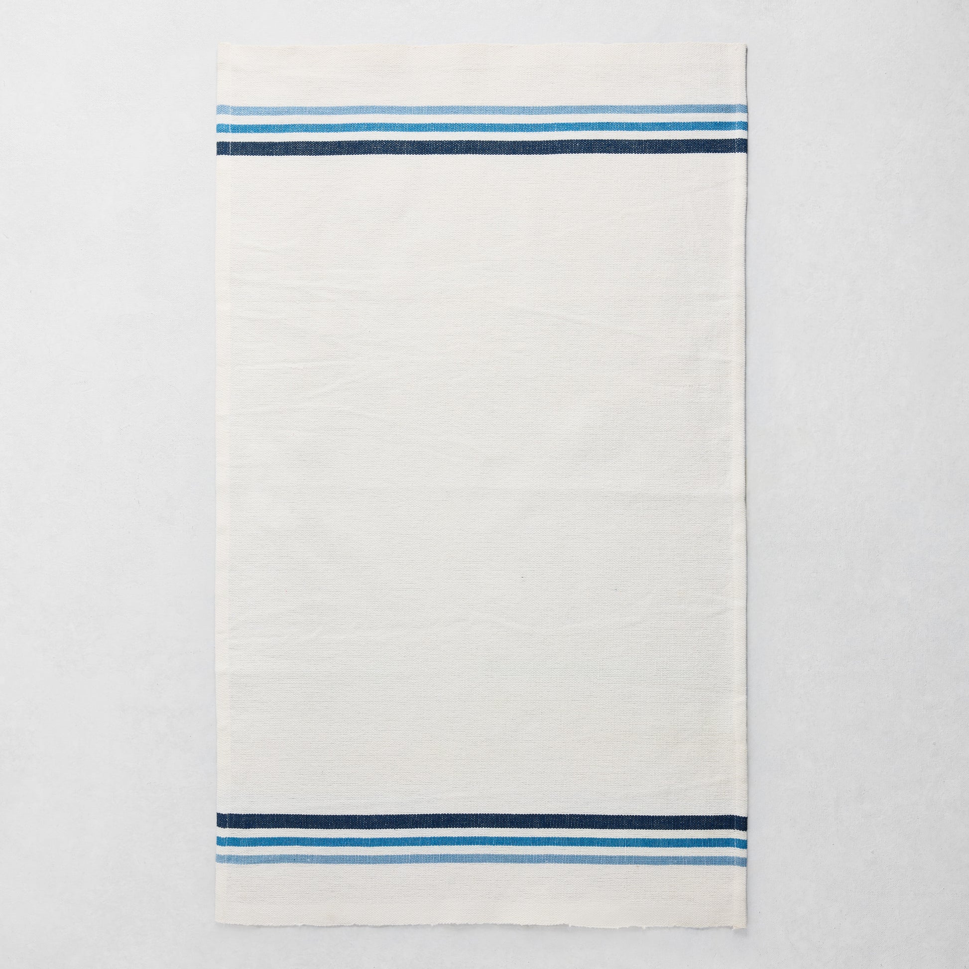 White cotton-linen hand towel with blue triple stripes at top and bottom, 28"L x 18"W.