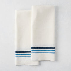Set of 2 white cotton-linen hand towels with blue triple stripes, folded.