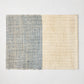 Blue and beige woven abaca and jute rectangular placemat with half and half pattern.