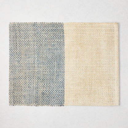 Blue and beige woven abaca and jute rectangular placemat with half and half pattern.