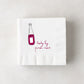 White 3-ply paper cocktail napkin with a red wine bottle illustration and "body by pinot noir" text.