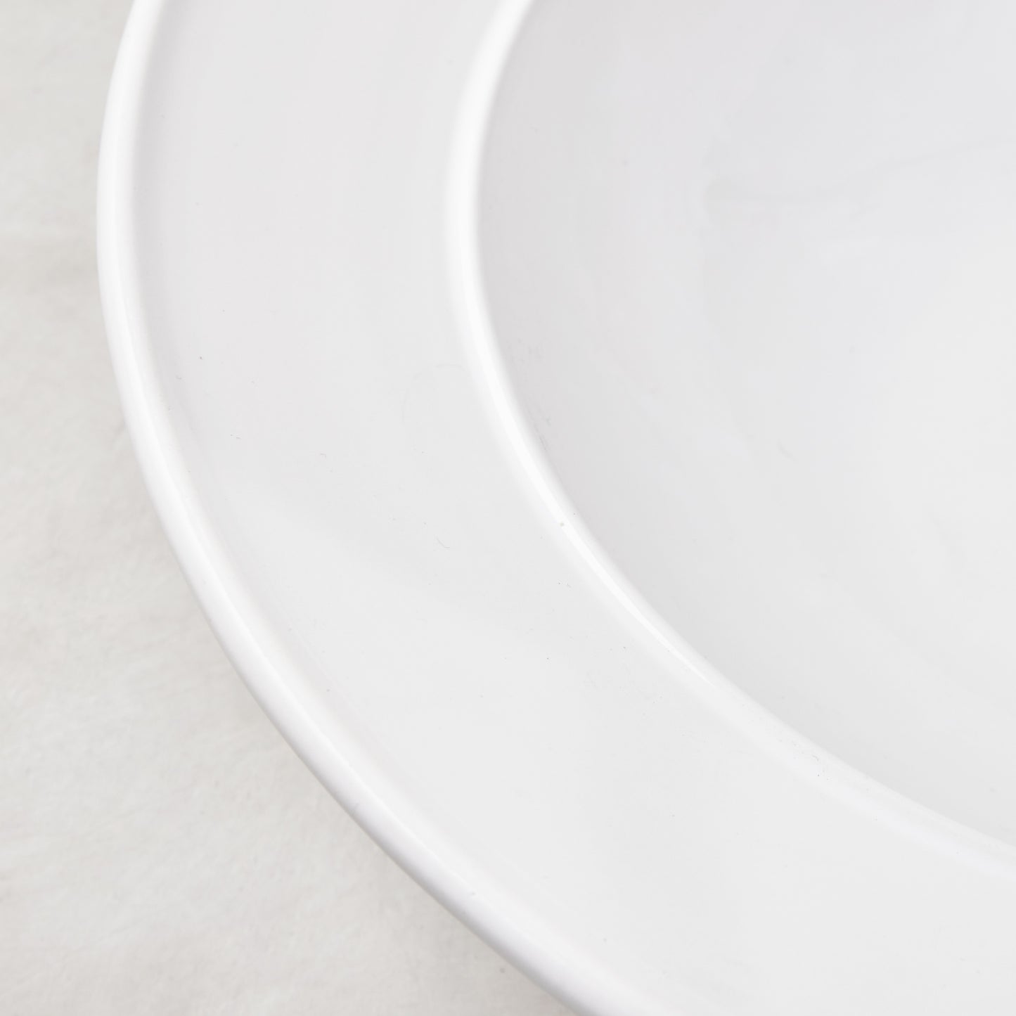 Bolinas white ceramic serve bowl with a raised edge trim, handmade in Italy.