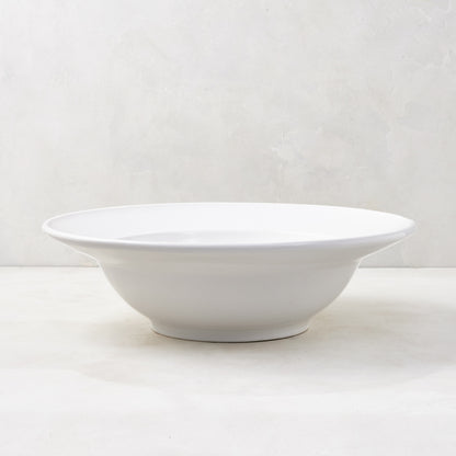 Bolinas 16" white ceramic serve bowl with a raised edge trim, handmade in Italy.