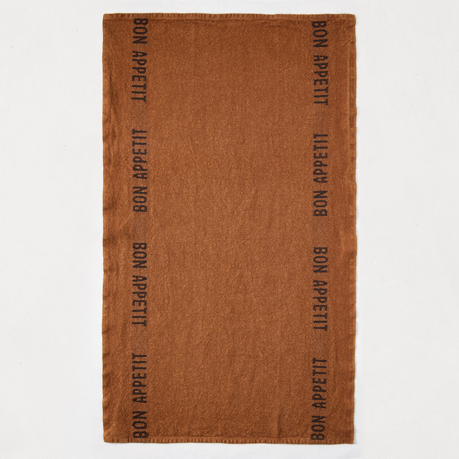 Brown linen hand towel with "BON APPETIT" printed vertically in black on both sides.
