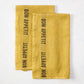 Set of 2 Goldenrod Yellow Linen Hand Towels with "BON APPETIT" in black lettering.