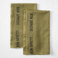 Set of 2 dark green linen hand towels with "BON APPETIT" in black lettering.