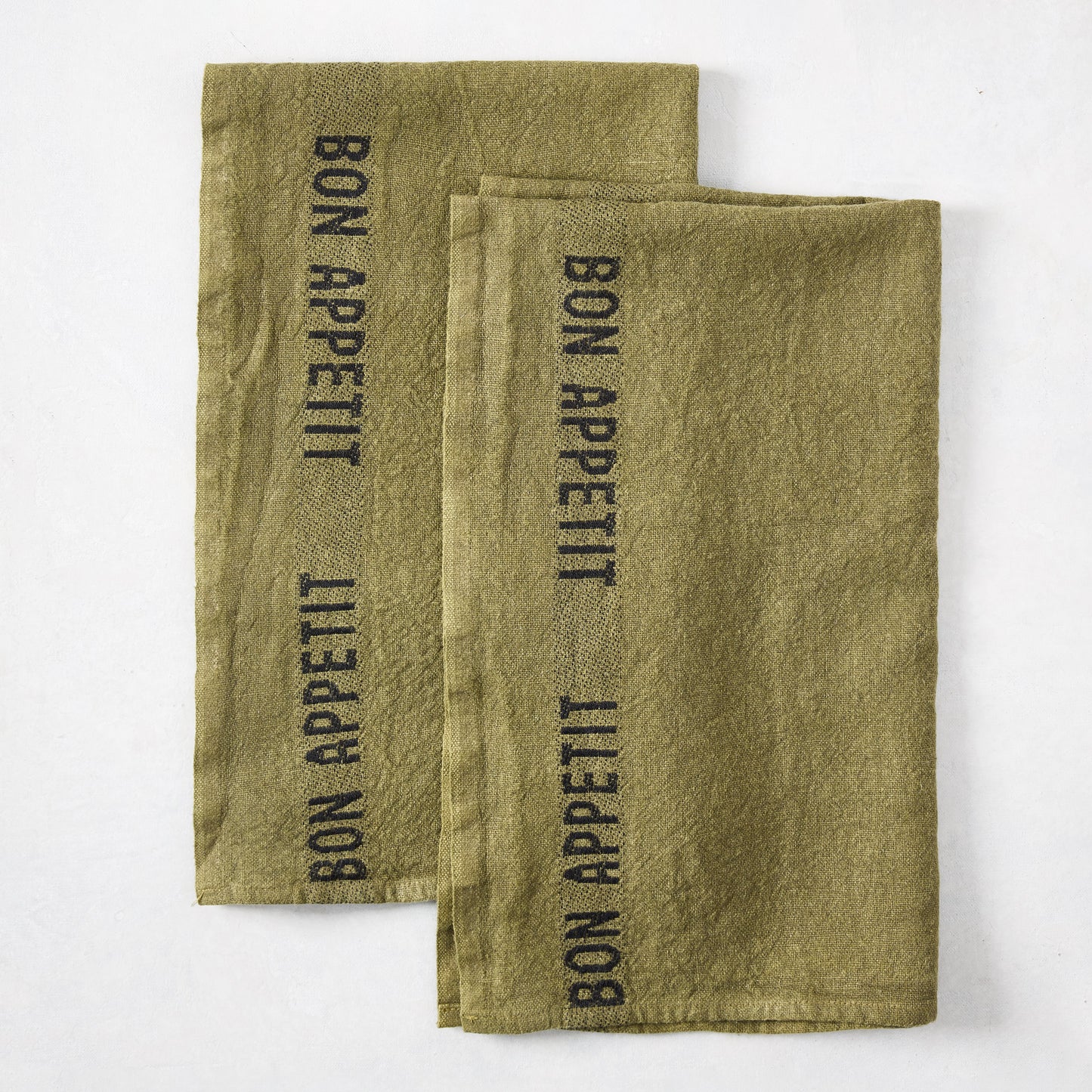Set of 2 dark green linen hand towels with "BON APPETIT" in black lettering.
