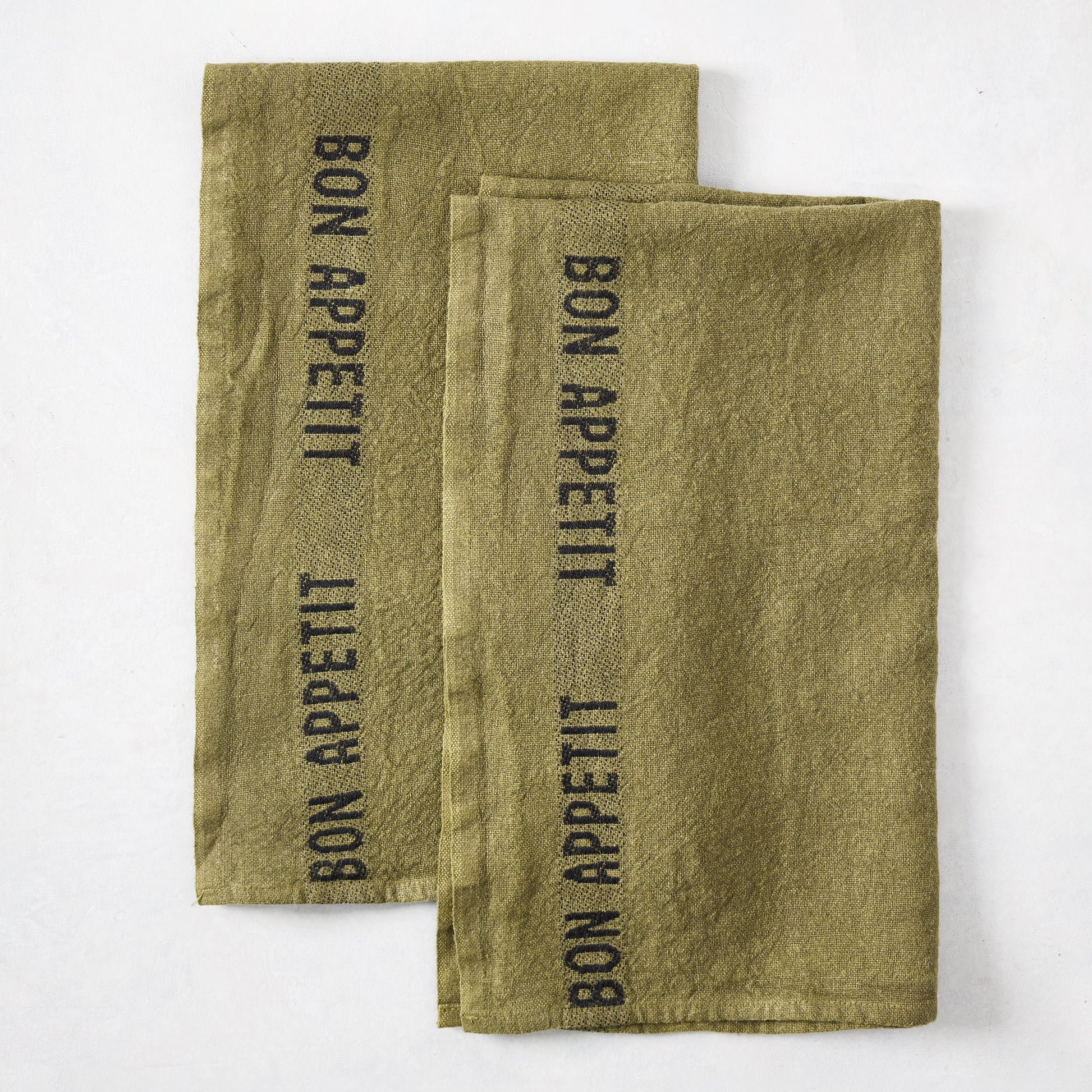 Set of 2 dark green linen hand towels with "BON APPETIT" in black lettering.