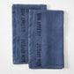 Set of 2 indigo blue linen hand towels with "BON APPETIT" in black lettering.