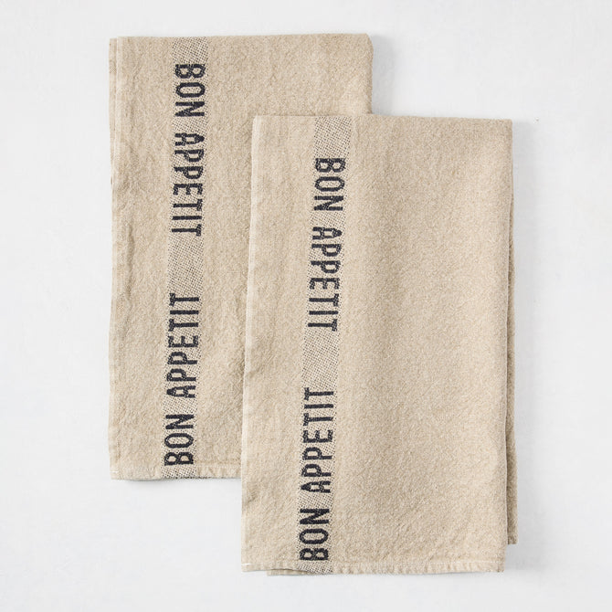 Set of 2 khaki linen hand towels with "BON APPETIT" in black lettering, folded on a white surface.