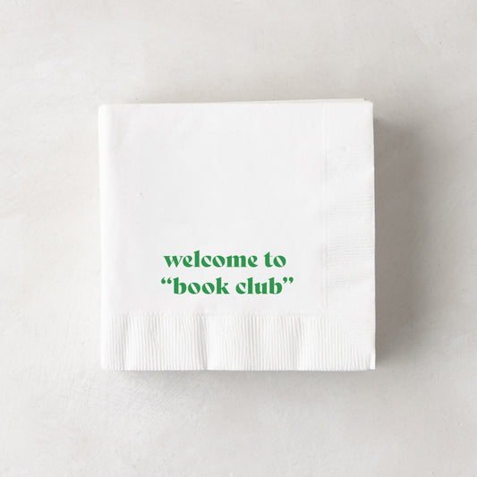 White 3-ply paper cocktail napkins with "welcome to 'book club'" in green text.