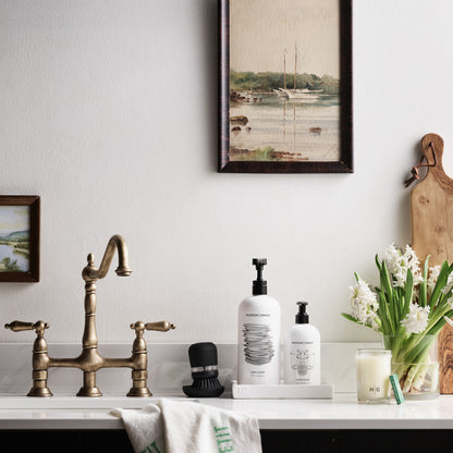 Bright green "Bon Appetit" linen hand towel draped over a kitchen sink.