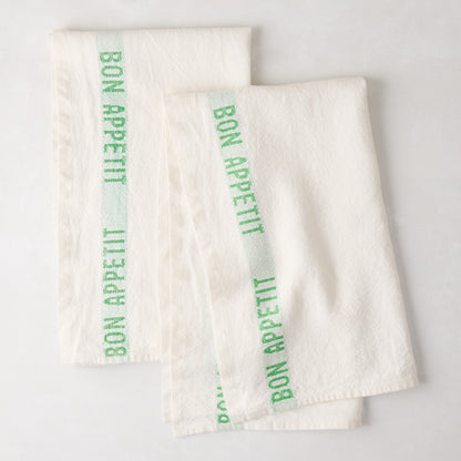 Set of 2 white linen hand towels with a bright green "Bon Appetit" stripe.