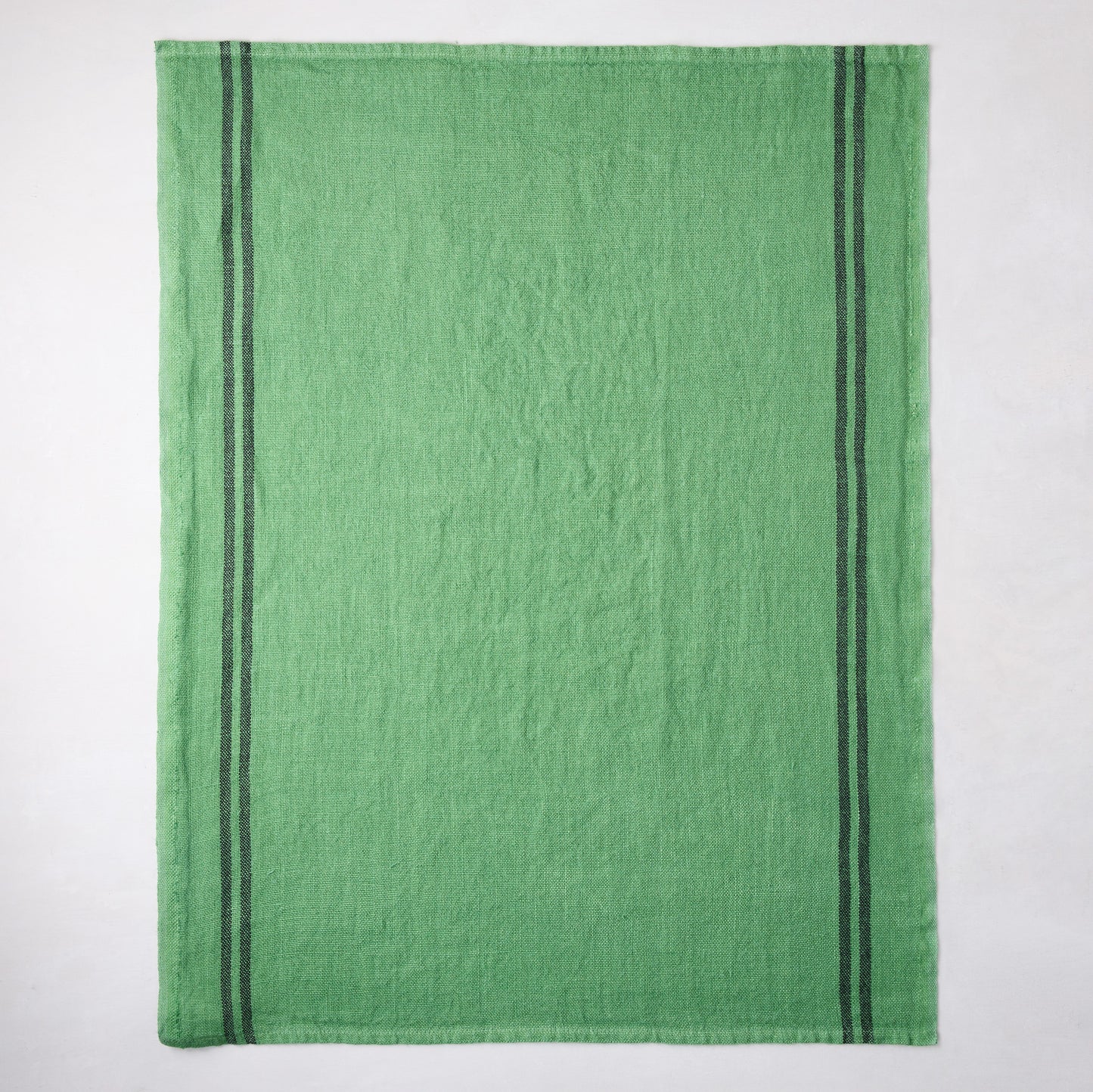 Bright green French linen towel with two dark gray vertical stripes.