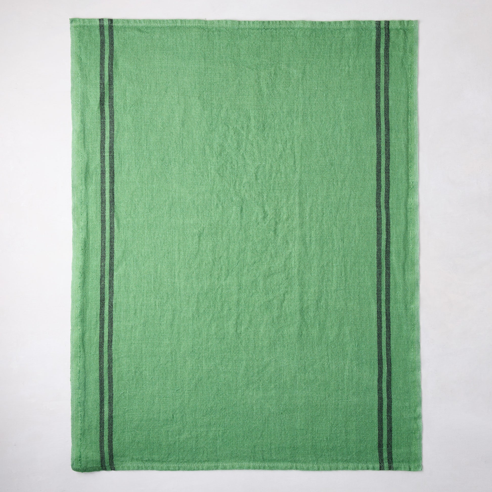 Bright green French linen towel with two dark gray vertical stripes.