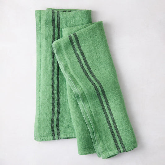 Set of 2 bright green French linen towels with dark gray stripes, folded.
